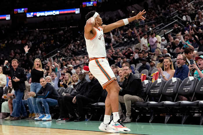 Dec 15, 2023; San Antonio, Texas, USA; San Antonio Spurs forward Keldon Johnson (3) reacts after scoring a three pointer during the first half against the Los Angeles Lakers at Frost Bank Center.